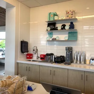 a kitchen with a counter and shelves