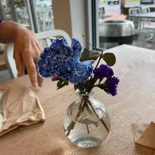 a person placing a flower in a vase