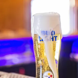 a glass of beer on a bar