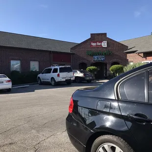 a black bmw parked in front of the restaurant