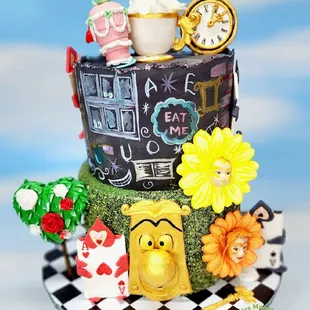 a cake made to look like alice and the mad hatter