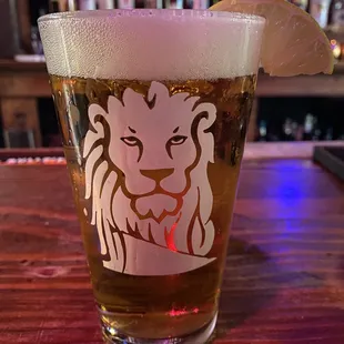 a glass of beer on a bar