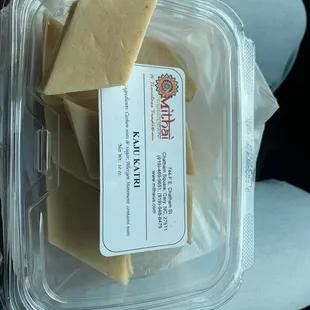 a piece of cheese in a plastic container