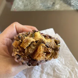 Purple rice burrito with Chinese donut, preserved cabbage, thousand year old egg, pork belly.