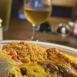Cheese enchilada, shredded beef taco, rice and beans