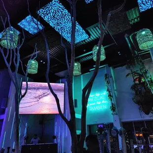 the interior of a restaurant with blue lighting