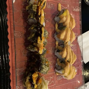 a plate of sushi and rolls