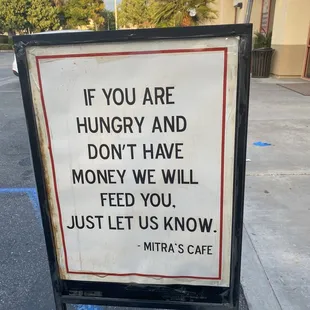 a sign saying if you are hungry and don&apos;t have money we will feed you just let us know