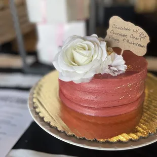 a cake with a rose on top