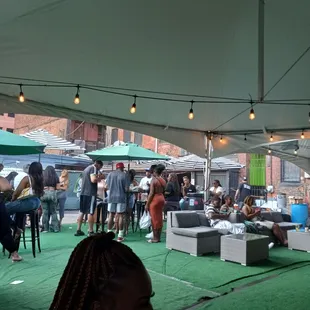 a crowd of people sitting under a tent