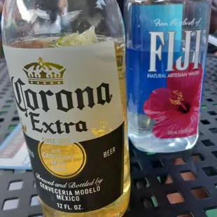 a bottle of corona extra and a bottle of fluo
