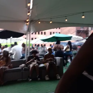 a group of people sitting under a tent