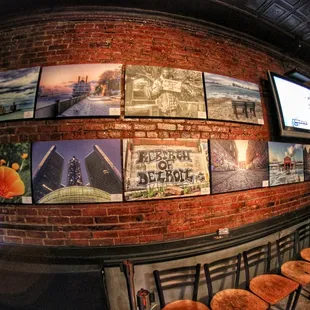 a brick wall with pictures on it