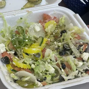 Greek salad with shredded iceberg lettuce.