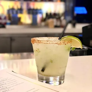 a margarita with a lime slice on the rim