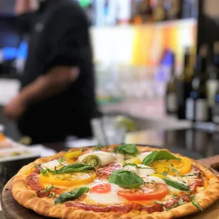 a pizza on a wooden platter
