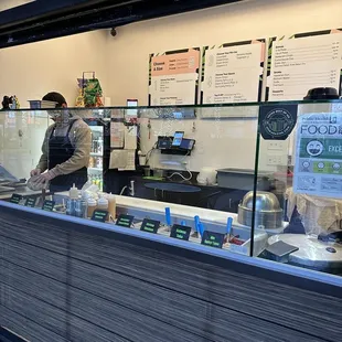 a man standing behind the counter