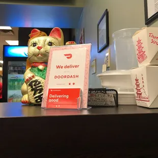 a cat and a box of food on a counter