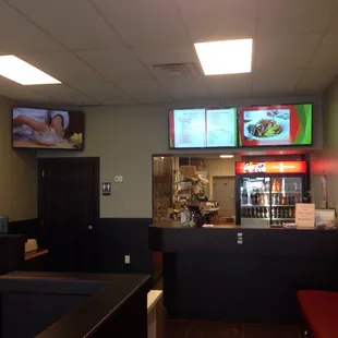 a restaurant with a bar and televisions
