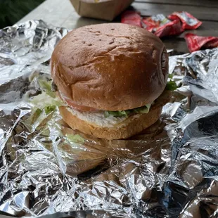 a burger on aluminum foil