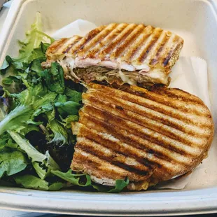 Cubano Panini - slow roasted soffrito pork, black forest ham, crisp dill pickle, baby swiss, yellow mustard, and roasted garlic aïoli.