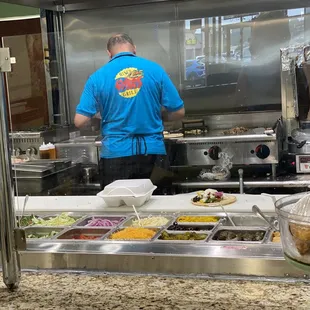 The chef at work (condiment bar in foreground)