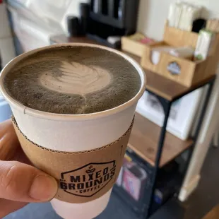 a hand holding a cup of coffee