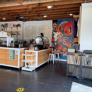 a coffee shop with vinyl records on the counter