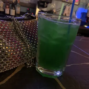 a green drink in a tall glass