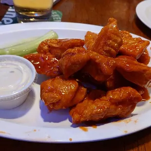 a plate of buffalo wings with ranch dressing