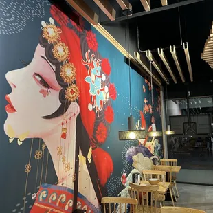 a woman's face on the wall of a restaurant