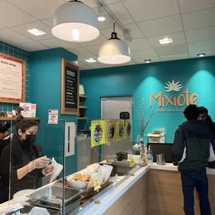 a woman ordering food at a counter