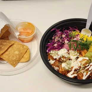 a bowl of food and a plate of chips