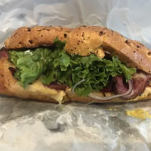 Pastrami on toasted onion roll with the works