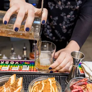 a person pouring a drink
