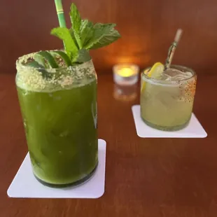 two cocktails on a wooden table