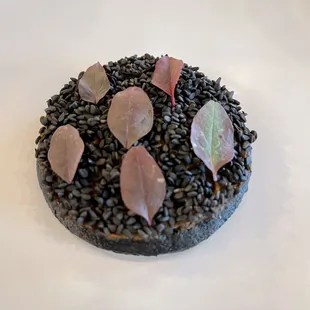 a chocolate cake with leaves on top