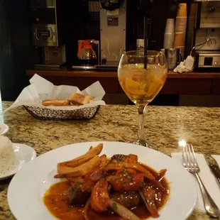 Lom o Salteado. Filet Mignon tips with sautéed onion, tomatoes, cilantro, and soy sauce served with fried potatoes wedges and white rice.