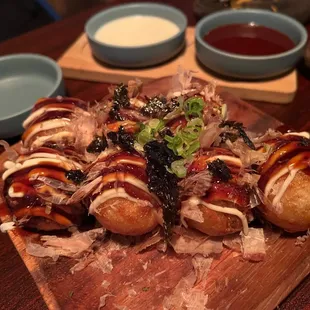 a wooden cutting board topped with hot dogs