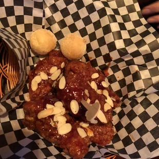 Season spicy chicken w 2 mini donuts under starter.