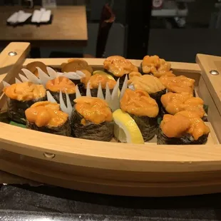 a wooden boat with sushi on it
