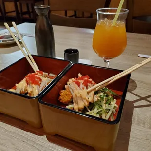 two bowls of sushi with chopsticks