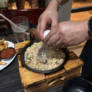 a person preparing food in a skillet