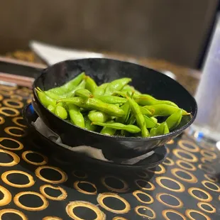 a bowl of green beans on a table