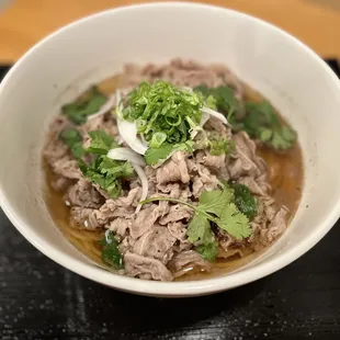Rice Noodle Ramen (PHO) a clear and lightly flavored broth, with rice noodles topped with thinly-sliced beef.