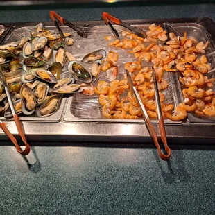 a variety of seafood on a grill