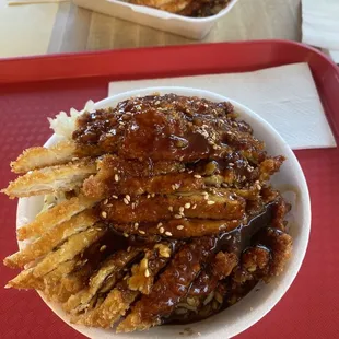 Regular sized sesame chicken bowl with rice and pickled cabbage