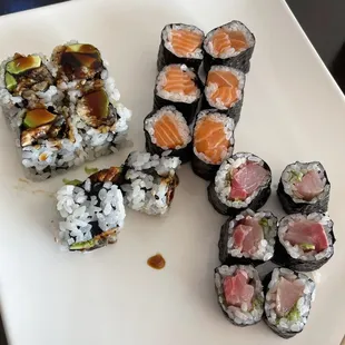 a plate of sushi and chopsticks