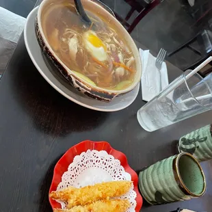 a bowl of soup and a plate of food on a table