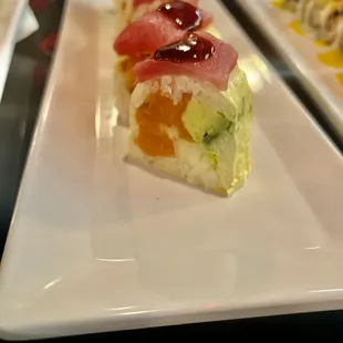 a plate of sushi and chopsticks